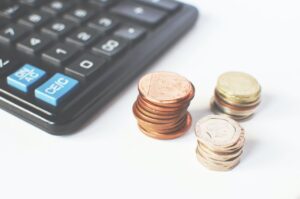 British coins next to a calculator