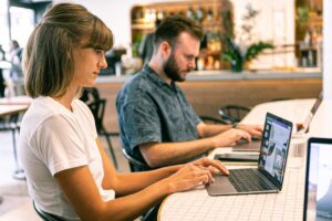 Young female and adult male at work in an office